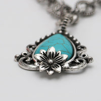 Vintage Style Turquoise Howlite Pendant Necklace, 18 Inch Silver Tone Chain, Floral Design with Ornate Frame